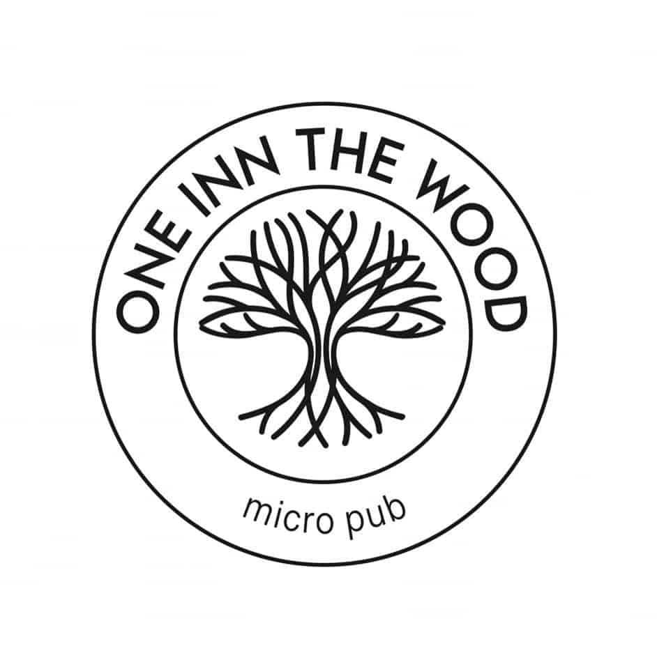 One Inn the Wood logo with tree design.