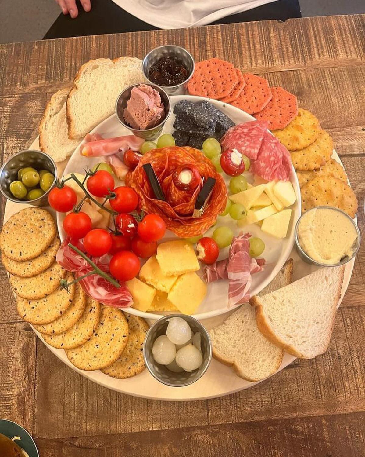Variety charcuterie board with meats, cheeses, and breads.